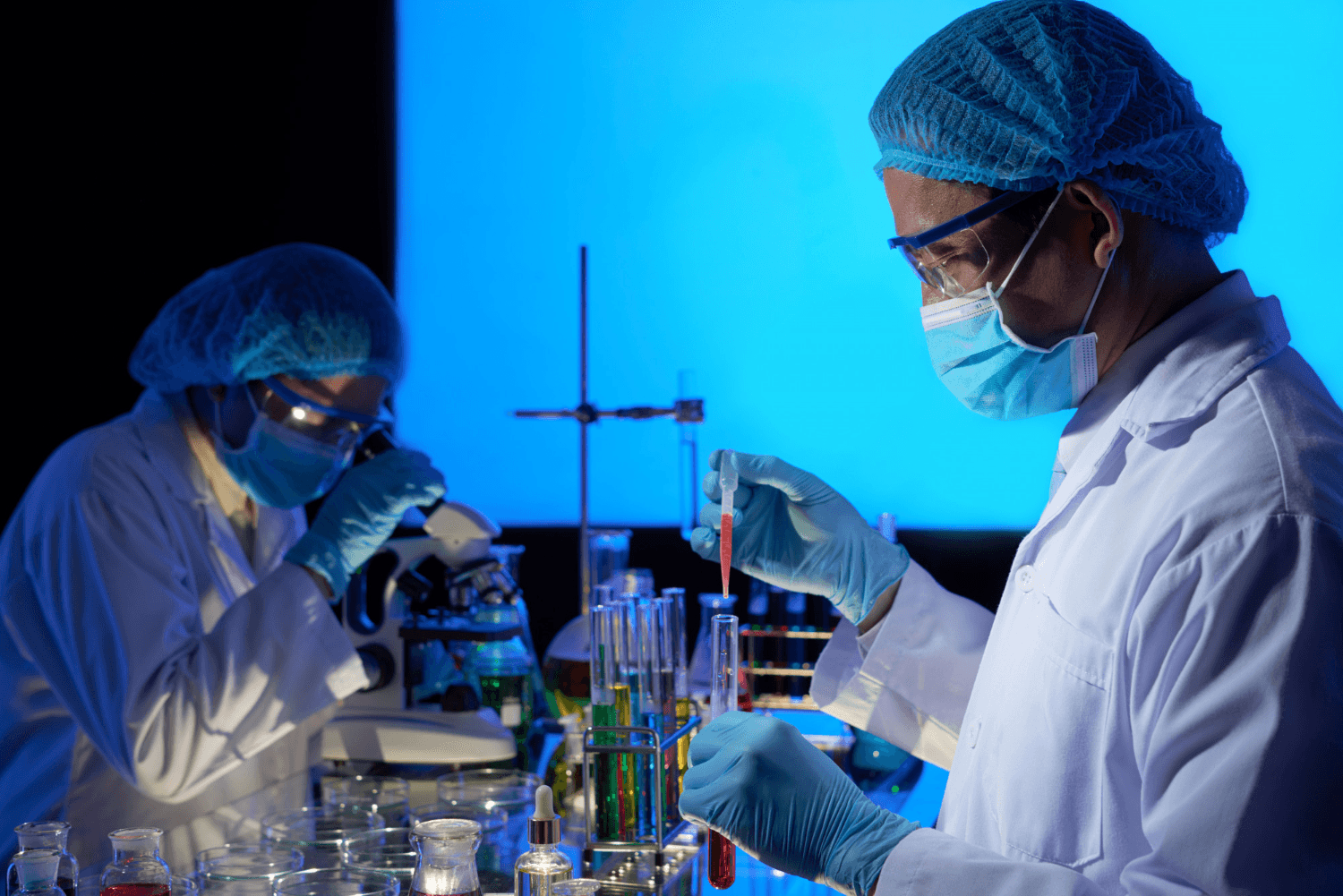 Pharma lab technicians reviewing sample vials
